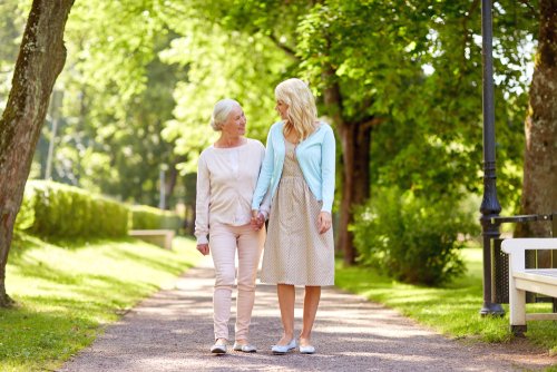 Elderly woman and her daughter going for a walk to stave off Sundowner’s Syndrome.