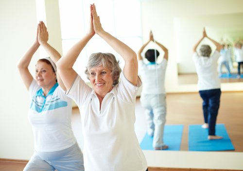 Elderly woman in an exercise class.