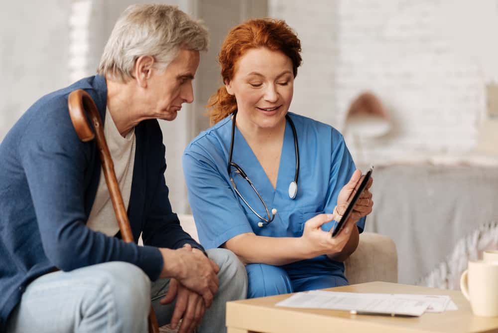 Homecare worker showing patient information