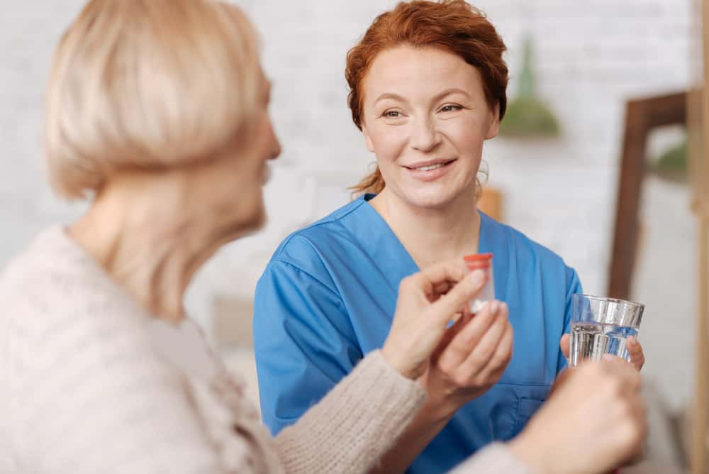 Caregiver giving client medication