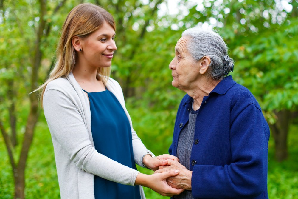 Woman caregiver with elderly patient with alzheimers