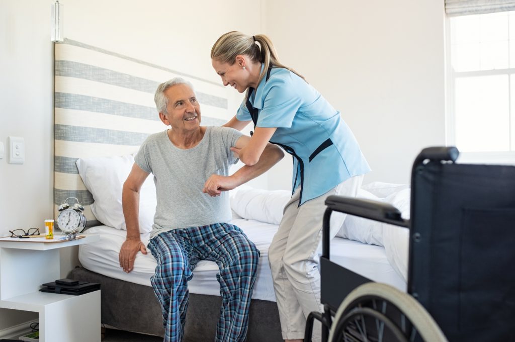 Elderly Man Assisted By A Home Health Aide